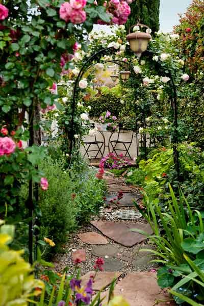 For a flower lover, what better place to sit could there be than at this bistro set, enjoying the view through a series of rose-covered arbors? | Photo: Mark Lohman | thisoldhouse.com