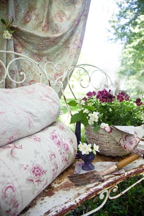 iron benches w/pretty fabric & baskets of flowers & a bit of shade....